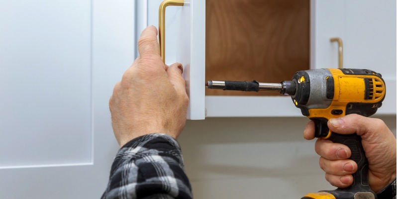 Homeowner installing door handle